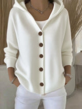 Women's white button-up knit cardigan with hood and front pockets, long sleeve lightweight sweater styled with white pants, available in sizes Small–5XL.
