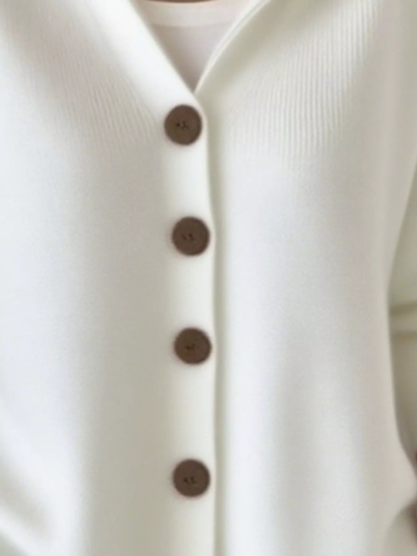 Women's white button-up knit cardigan with hood and front pockets, long sleeve lightweight sweater styled with white pants, available in sizes Small–5XL.