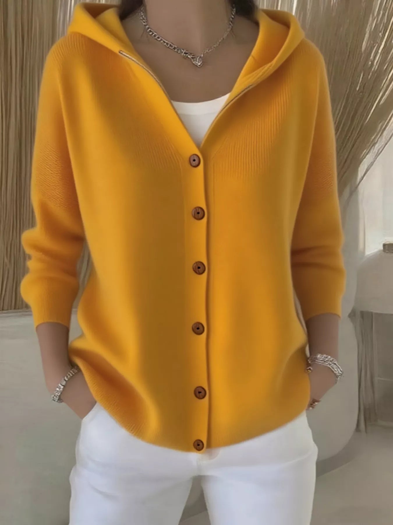Women's yellow button-up knit cardigan with hood and front pockets, long sleeve lightweight sweater styled with white pants, available in sizes Small–5XL.