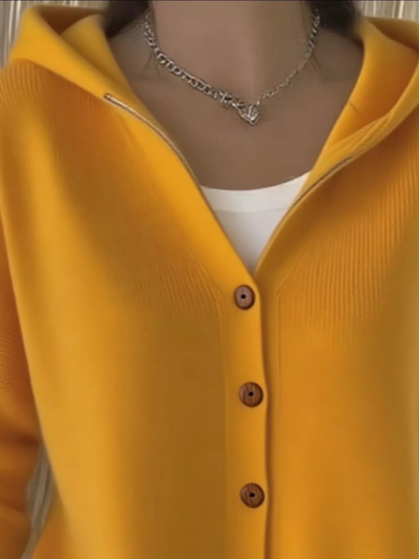 Women's yellow button-up knit cardigan with hood and front pockets, long sleeve lightweight sweater styled with white pants, available in sizes Small–5XL.