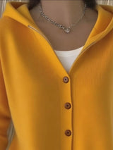 Women's yellow button-up knit cardigan with hood and front pockets, long sleeve lightweight sweater styled with white pants, available in sizes Small–5XL.