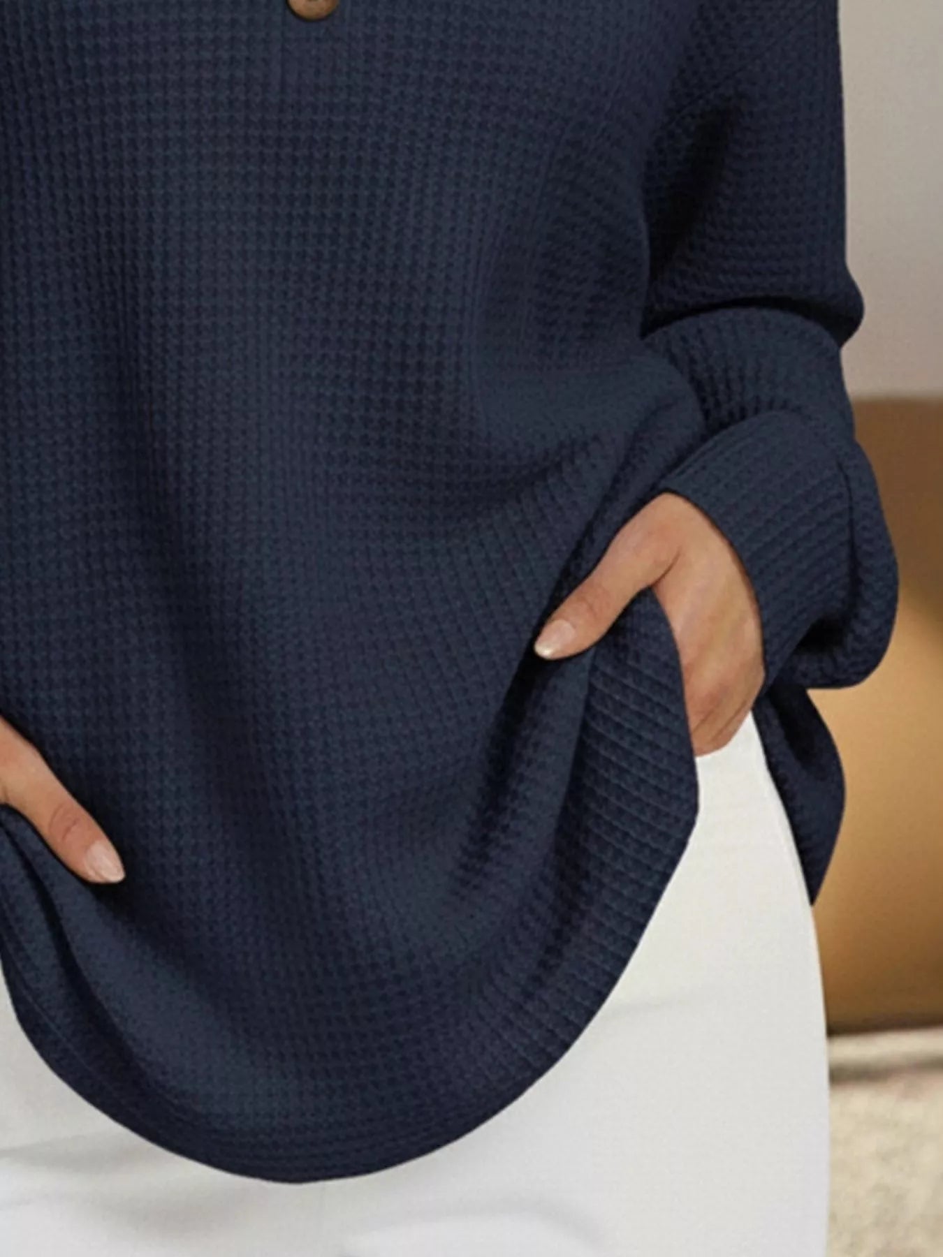 Navy blue textured sweater worn by a person with a neutral background