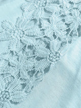 Close-up of pastel blue lace fabric with a soft-focus background