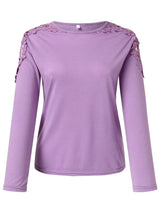 Pink purple long-sleeve top with floral embellishments on shoulders against a white background