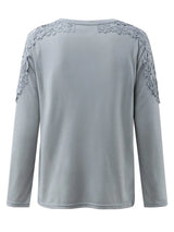 Gray long-sleeve top with lace details on a white background showcasing the back of the top.