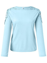 Pastel blue long-sleeve top with decorative elements on a white background