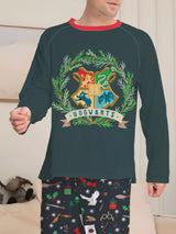 Family wearing matching dark green Hogwarts graphic Christmas pajama tops with coordinating navy holiday print pajama pants.