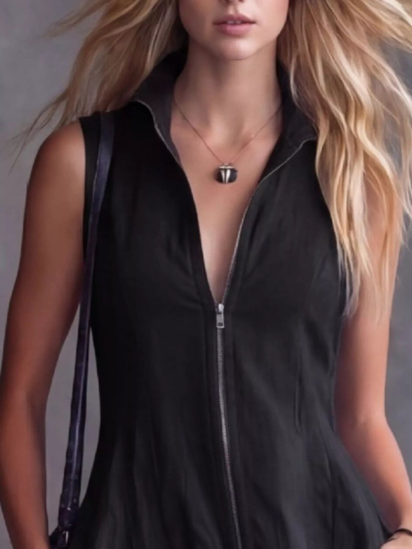 Women's black high-low ruffled sleeveless maxi dress featuring a zip-front closure. Elegant boutique dress perfect for fall festivals, winery weekends, date nights, and boho-inspired outfits.