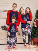 Family of four wearing matching Christmas pajamas with navy tops, red raglan sleeves, festive Christmas tree lettering, and coordinating printed pants.