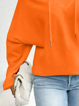 Person wearing an orange-red jacket with a white background