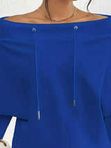 Blue off-shoulder top with a white background