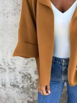 Women's Caramel open front 3/4 sleeve casual cardigan layered over a white V-neck tank with blue jeans, lightweight cardigan available in sizes Small–5XL.