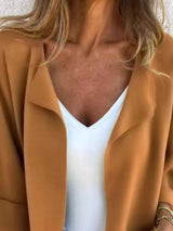 Women's Caramel open front 3/4 sleeve casual cardigan layered over a white V-neck tank with blue jeans, lightweight cardigan available in sizes Small–5XL.