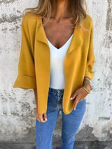 Women's Sherbet open front 3/4 sleeve casual cardigan layered over a white V-neck tank with blue jeans, lightweight cardigan available in sizes Small–5XL.