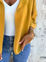 Women's Sherbet open front 3/4 sleeve casual cardigan layered over a white V-neck tank with blue jeans, lightweight cardigan available in sizes Small–5XL.