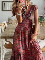 Women's paisley print tiered maxi dress with cap sleeves, smocked bodice, and flowing ruffle skirt, available in sizes Small–3XL, styled with sandals and a denim jacket for fall.