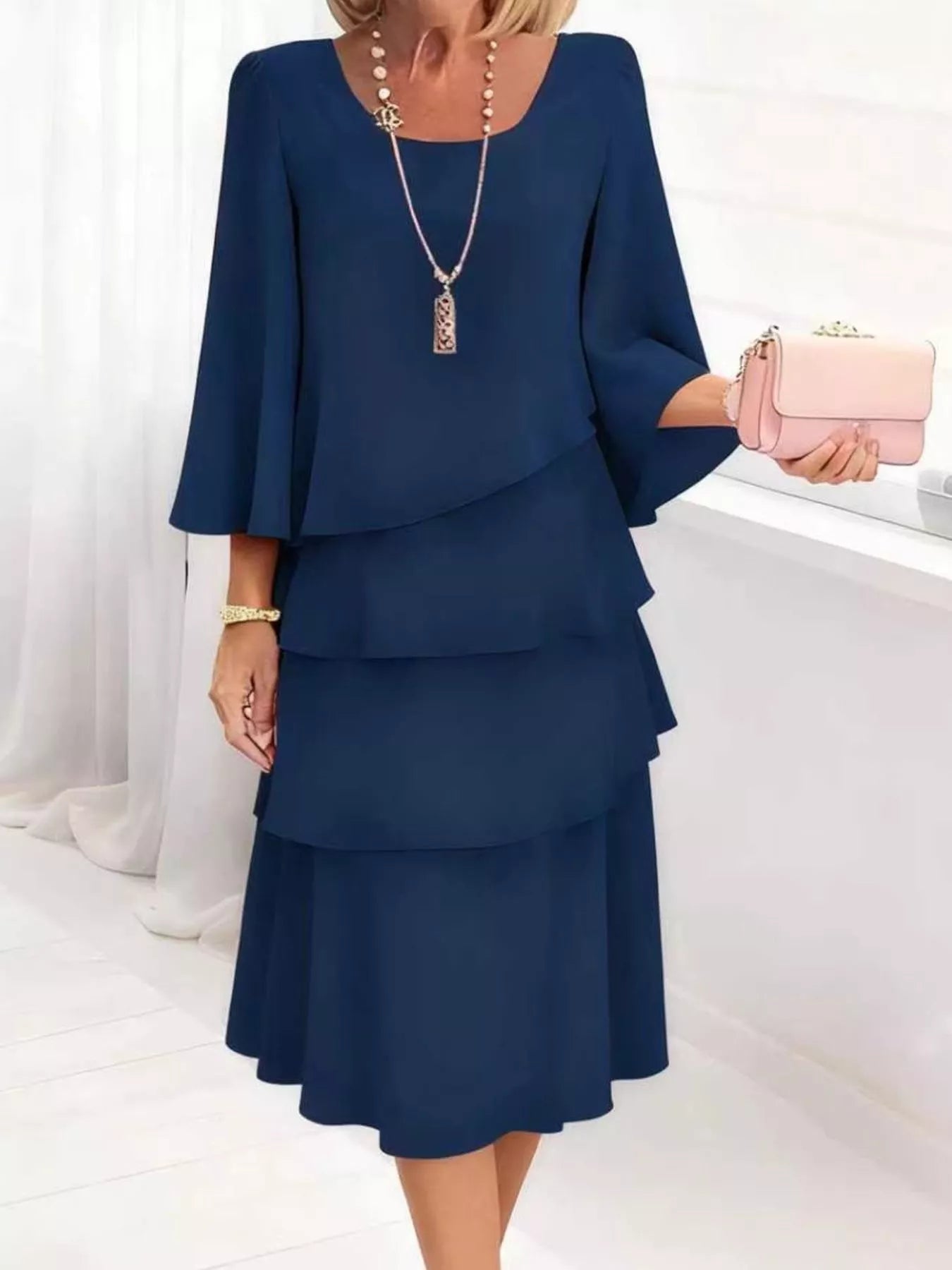 Woman wearing a blue dress with a white background