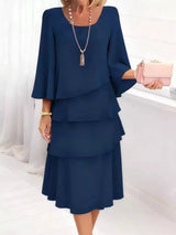 Woman wearing a blue dress with a white background