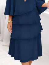 Blue layered dress on a white background