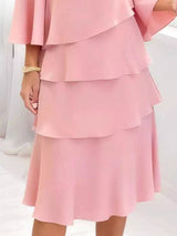 Pink layered dress on a white background