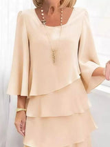 White layered dress worn by a person on a white background