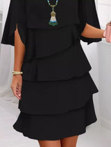 Black layered dress worn by a person on a white background