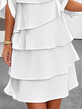 White tiered dress on a neutral background