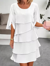 White layered dress worn by a person in an indoor setting