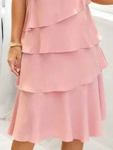 Blush pink tiered dress on a white background