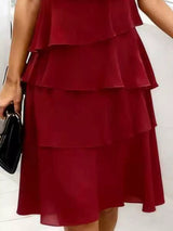 Burgundy tiered dress worn by a person on a white background