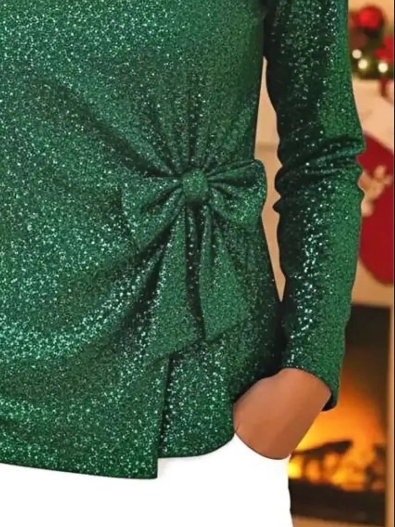 Green sequin top with a large bow detail on a blurred background