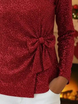 Red glittery top with a knot detail on a blurred background