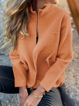 Women's orange textured knit zip-up outerwear jacket with decorative button pockets, lightweight fall jacket available in sizes Small–5XL, styled over a white tank and black jeans.