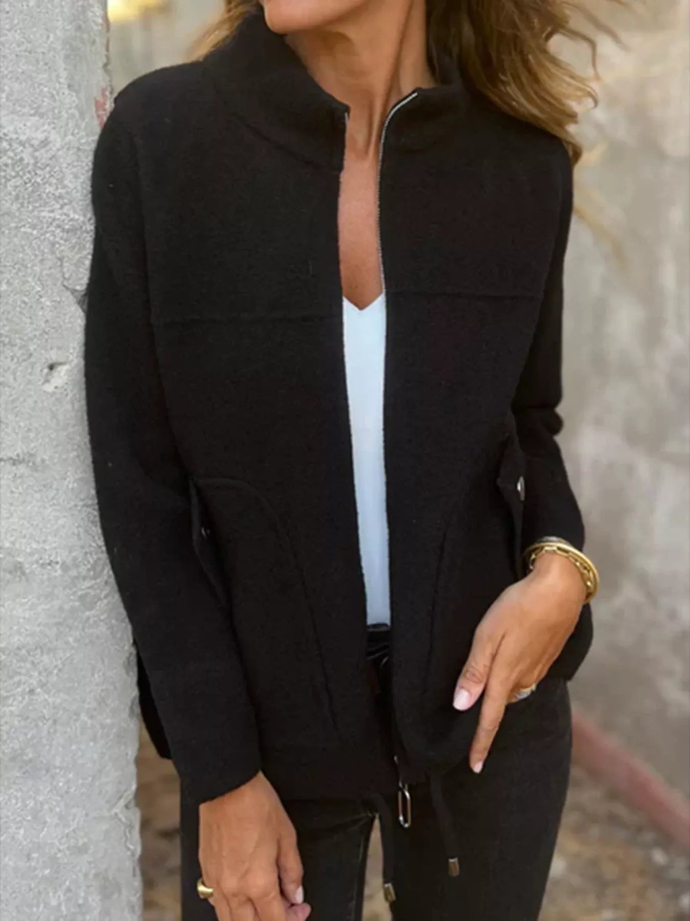 Women's black textured knit zip-up outerwear jacket with decorative button pockets, lightweight fall jacket available in sizes Small–5XL, styled over a white tank and black jeans.
