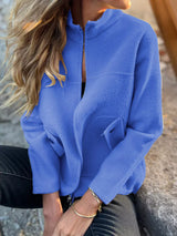 Women's blue textured knit zip-up outerwear jacket with decorative button pockets, lightweight fall jacket available in sizes Small–5XL, styled over a white tank and black jeans.