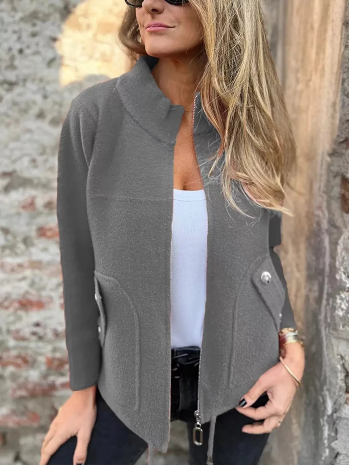Women's gray textured knit zip-up outerwear jacket with decorative button pockets, lightweight fall jacket available in sizes Small–5XL, styled over a white tank and black jeans.