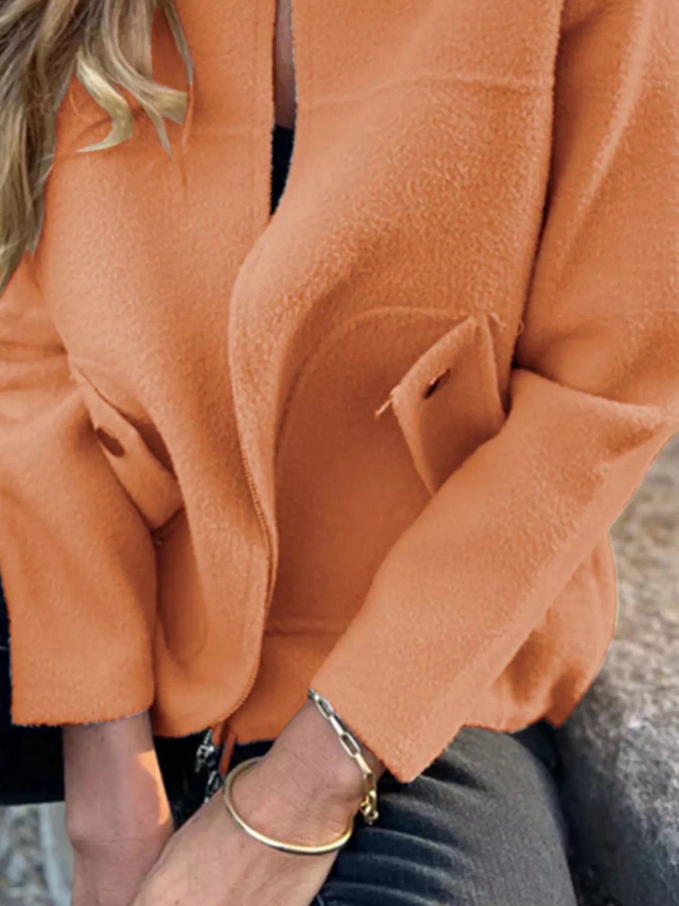 Women's orange textured knit zip-up outerwear jacket with decorative button pockets, lightweight fall jacket available in sizes Small–5XL, styled over a white tank and black jeans.