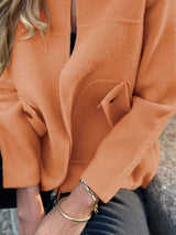 Women's orange textured knit zip-up outerwear jacket with decorative button pockets, lightweight fall jacket available in sizes Small–5XL, styled over a white tank and black jeans.