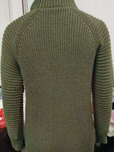 Woman wearing an army green turtleneck raglan sleeve sweater dress paired with white knee-high boots and a white crossbody bag for a chic fall outfit.