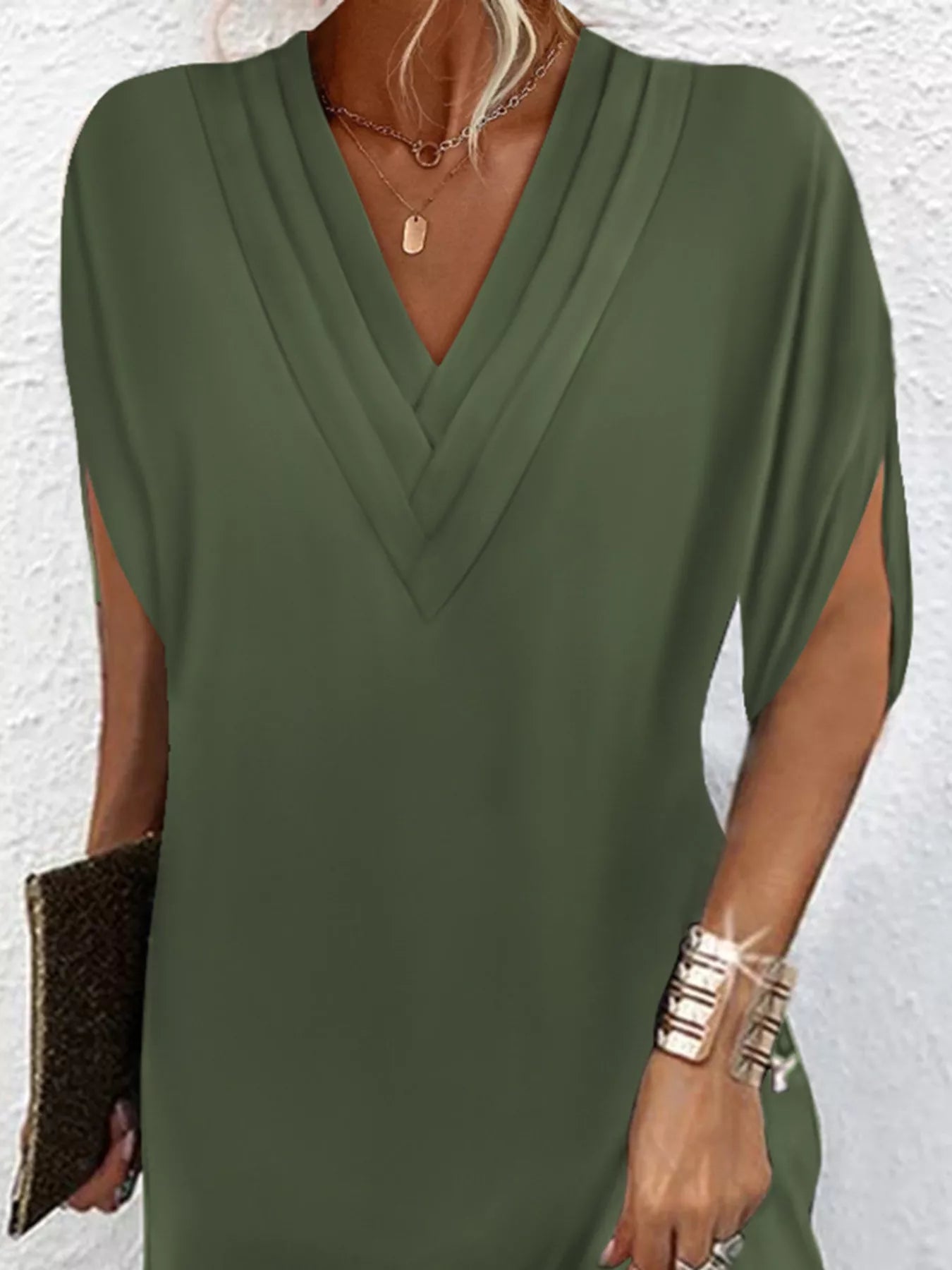 Green dress worn by a person against a white background