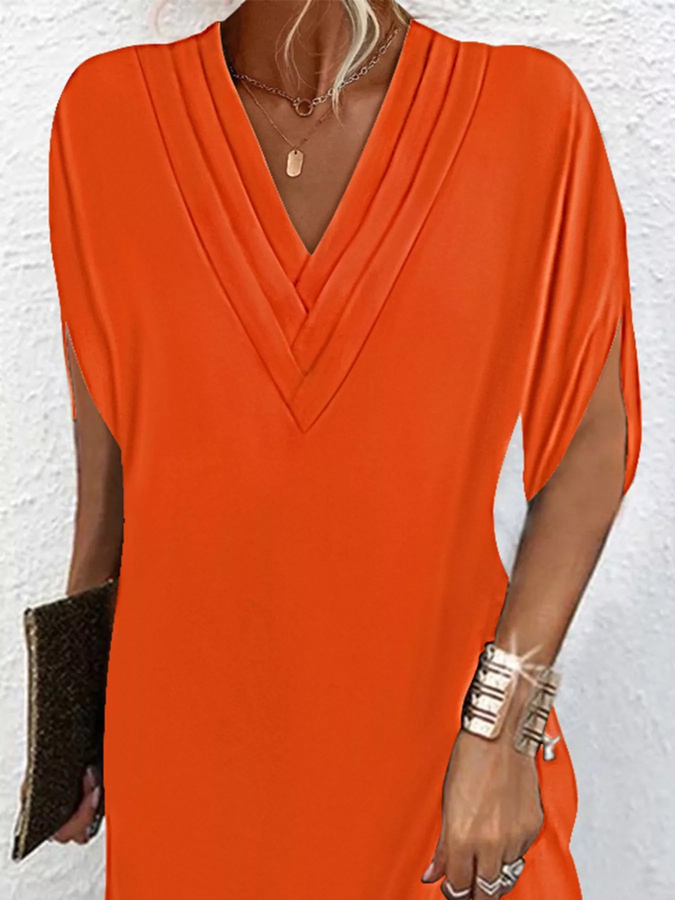 Orange dress worn by a person against a white background