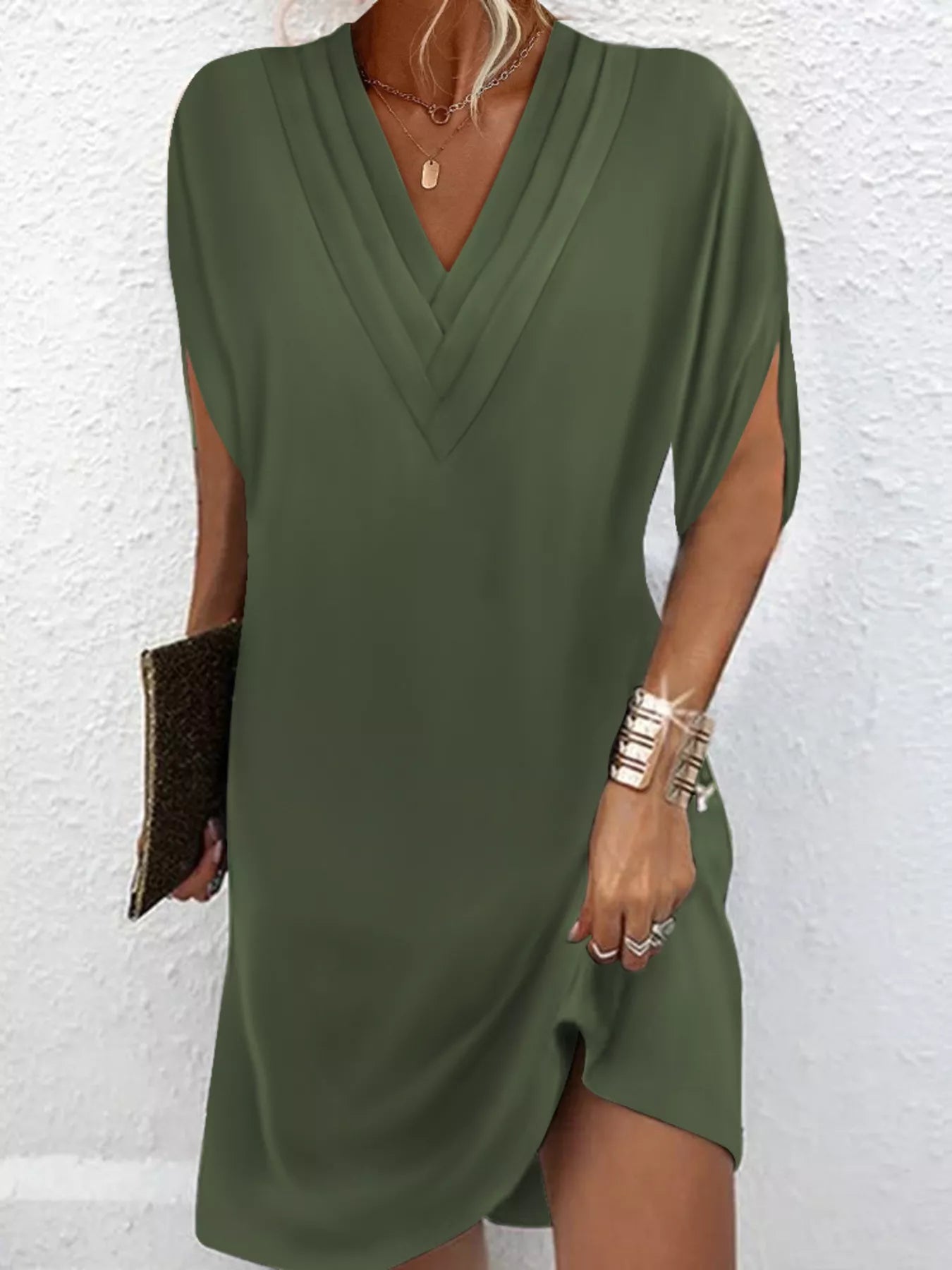 Green dress worn by a person on a white background