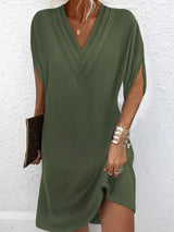 Green dress worn by a person on a white background