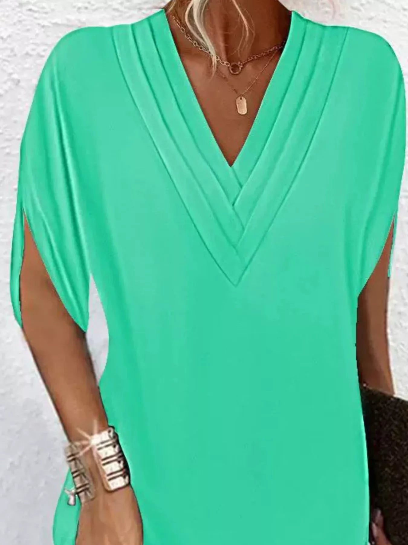 Green dress with a V-neck on a white background