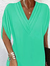 Green dress with a V-neck on a white background