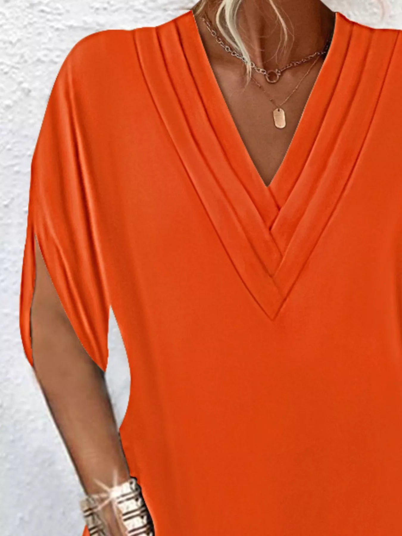 Orange dress worn by a person with a white background