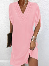 Pink dress worn by a person on a white background