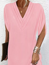 Person wearing a pink dress with a white background