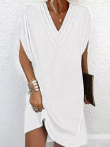 White sleeveless dress worn by a person on a white background