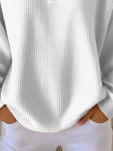 White textured sweater worn by a person with white pants